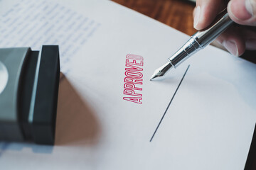 Business Man Hand Stamping On Approved Contract Form. Notary stamping documents.