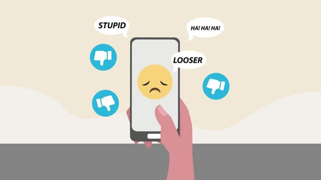 Hand using a mobile phone with insulting messages