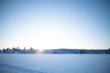 Frozen Lake in Swedish Taiga with Forests and Sunset