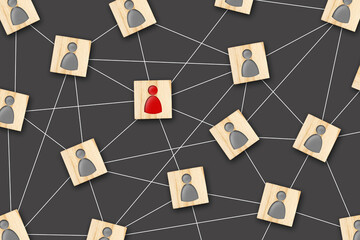 Social networking concept. Wooden blocks with gray and red human icons are connected to each other....