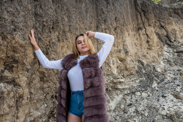 young  fashion woman posign in sand mountains