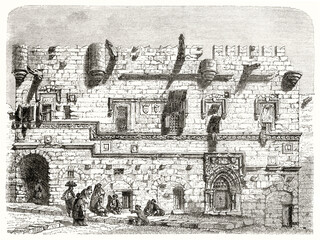 Front view Priory of France facade in Rhodes. Stone made edifice with battlements roof. Ancient grey tone etching style art by Riou, Le Tour du Monde, 1862