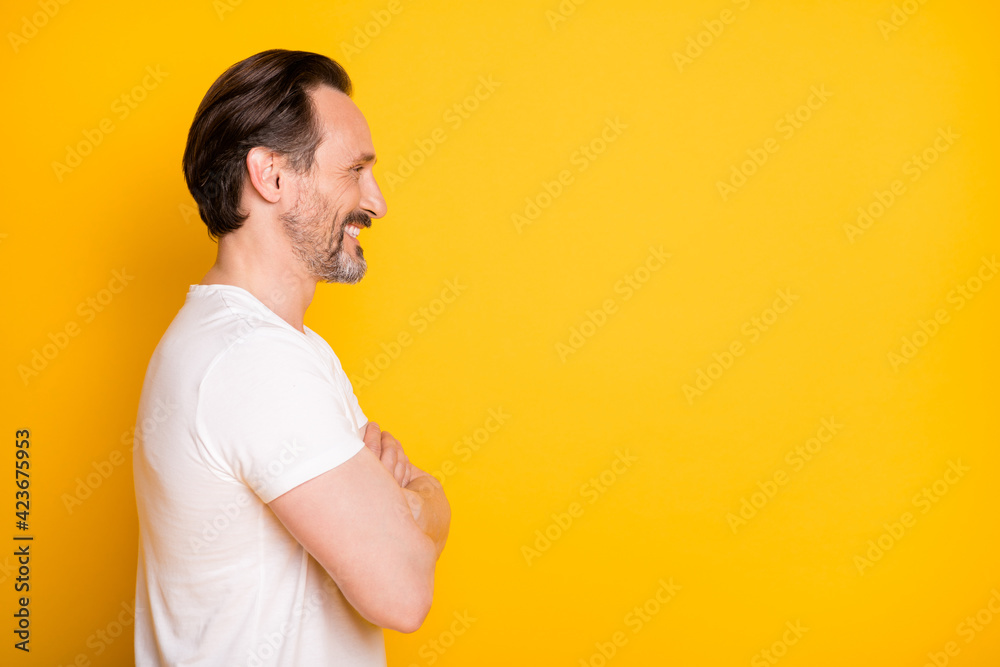 Wall mural profile side photo of happy cheerful handsome man crossed hands look empty space isolated on yellow 