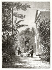 elegant people having conversation in a luxuriant garden of a colonial house in Saint-Pierre, Reunion island. Ancient grey tone etching style art by Stock, Le Tour du Monde, 1862