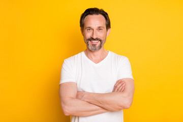 Photo of confident bearded man crossed arms toothy beaming smile wear white t-shirt isolated yellow...