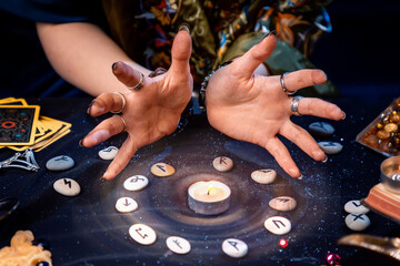 A fortune teller conjures a candle surrounded by runes and the magic aura. The concept of divination, astrology and predicting the future