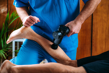Therapist Treating Patient’s Calf with Massage Gun