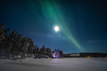 The northern lights over a frozen river in Swedish Lapland