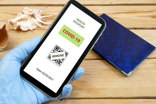 Vaccination passport on a mobile phone allowing travel in hand. Vaccination against the coronavirus Covid 19.Imunity or Health passport