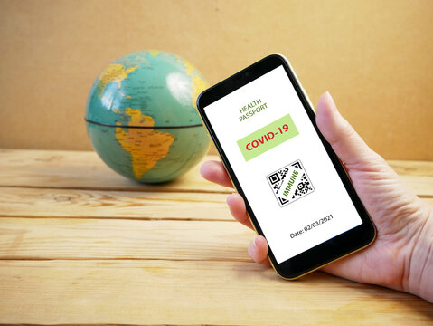 Vaccination passport on a mobile phone allowing travel in hand. Vaccination against the coronavirus Covid 19.Imunity or Health passport