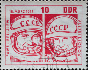 GERMANY, DDR - CIRCA 1965  : a postage stamp from Germany, GDR showing the cosmonauts Pavel Belyayev and Alexej Leonow in a space suit. Start of the Soviet spaceship  Vozhod 2