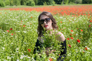 Beautiful young woman in field of flowers daisies, enjoy nature