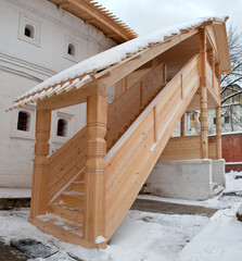 Wooden staircase to the stone chambers.