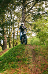 Obraz premium Young man with helmet riding a custom motorbike outdoors