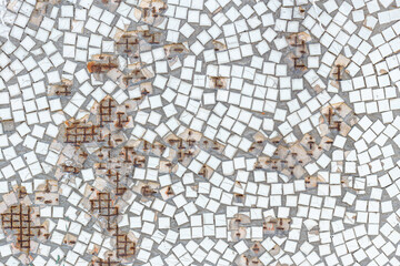 Old white mosaic wall with hole and rust, background from old mosaic.