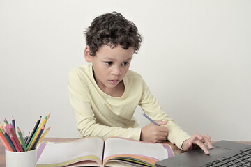 little boy learning at school on white background stock photo