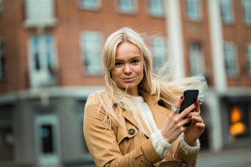 Woman on street using smart phone.