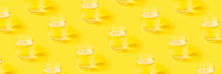 Summer pattern with glasses of lemonade on yellow background.