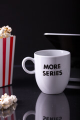 Home Cinema, laptop computer. Watching tv series with 2 boxes of pop corn.