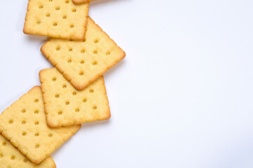 line of crackers put on white table with empty space