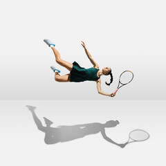Young caucasian professional sportswoman levitating, flying while playing tennis isolated on white background