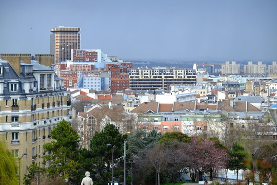 A view on the parisian suburbs from a hill of the north of Paris. "Butte du chapeau rouge" the hill of the red hat, a park in the north of Paris. the 21st march 2021.