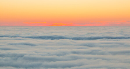 Fototapeta na wymiar The sunset over a sea of clouds