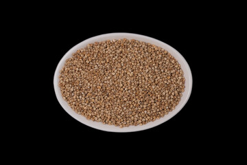 quinoa seeds in a in small white, oval ceramic bowl