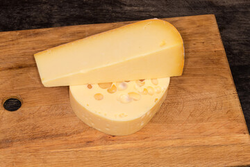 Two types of semi-hard cheese on cutting board