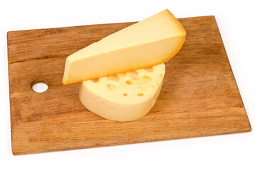 Two pieces of various semi-hard cheese on cutting board
