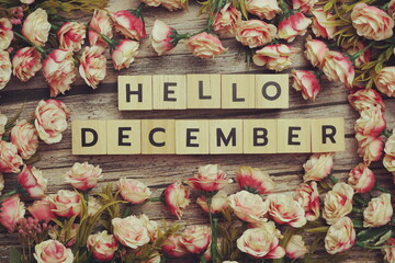 Hello December alphabet letters with pink flower decoration on wooden background - Powered by Adobe