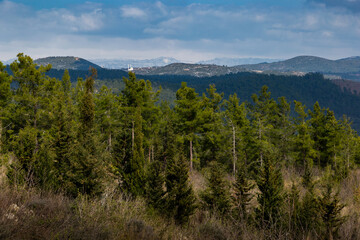 Obraz premium Summer landscape. Blue sky with clouds over the mountain ridge in the distance.
