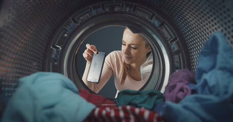 Woman finding her smartphone in the washing machine