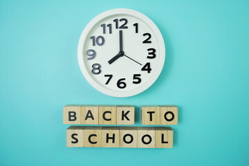 Back to School with clock on blue background