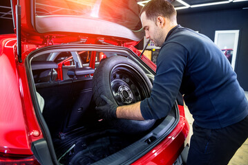 Car service worker disassemble the interior of the car