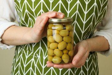 Woman hold jar of olives, close up - obrazy, fototapety, plakaty
