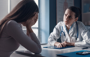 Doctor assisting a crying patient in the office