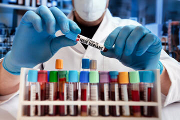 Laboratory Technician with a blood sample test tube with a New Variant of Coronavirus. Doctor in...
