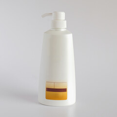 White glossy plastic bottle with dispenser for liquid soap, shampoo, shower gel, lotion, body oil.