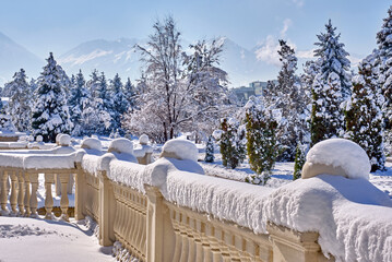 Freshly fallen snow on the decorative railing in the winter season; modern architectural forms