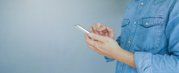 close up man hand using smartphone to searching on website or read content social media application...