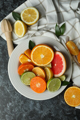 Concept of ripe food with different citrus on black smoky table