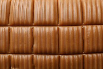 Tasty caramel bar on whole background, close up