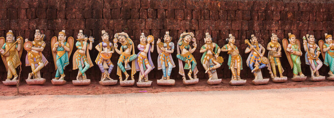 A Group of Colorful dolls  representing the Indian Musician and Dancing girls  in different postures, made in Plaster of Paris  adorns the exterior of a Jain temple in Karnataka.