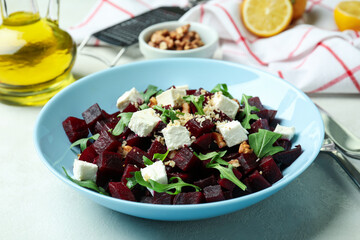 Concept of tasty eating with beet salad on white textured table