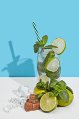 Mojito cocktail on double white blue background with shadow.