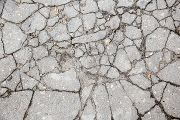 The remains of cracked asphalt on the ground. Top view