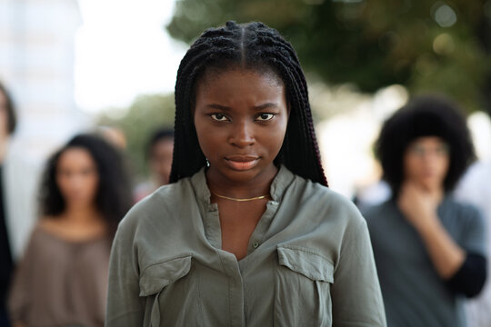 Closeup of black lady over demonstrators making riot outdoors