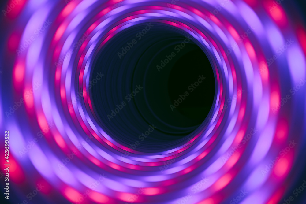Poster beautiful abstract swirl tunnel with pink and blue neon light on a background pttern textured for de