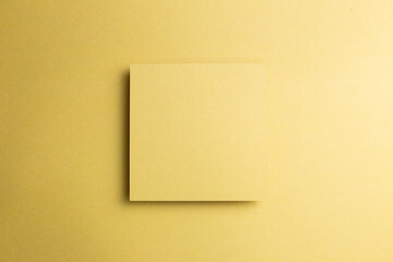 Blank memo pad on yellow gold background. top view, copy space